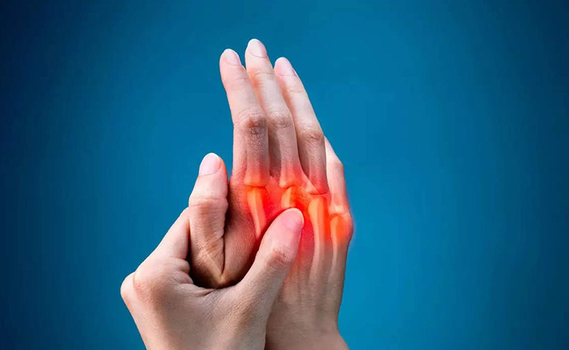 Person writing Arthritis with pen