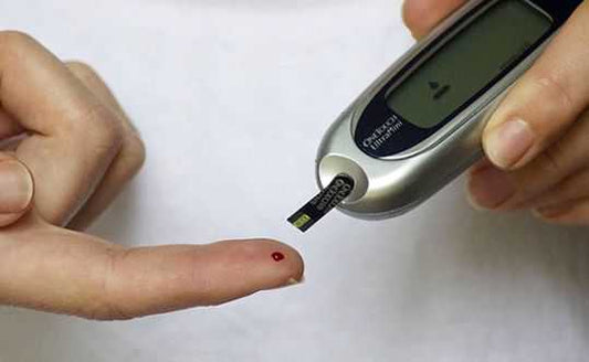 Glucometer testing blood to check sugar levels