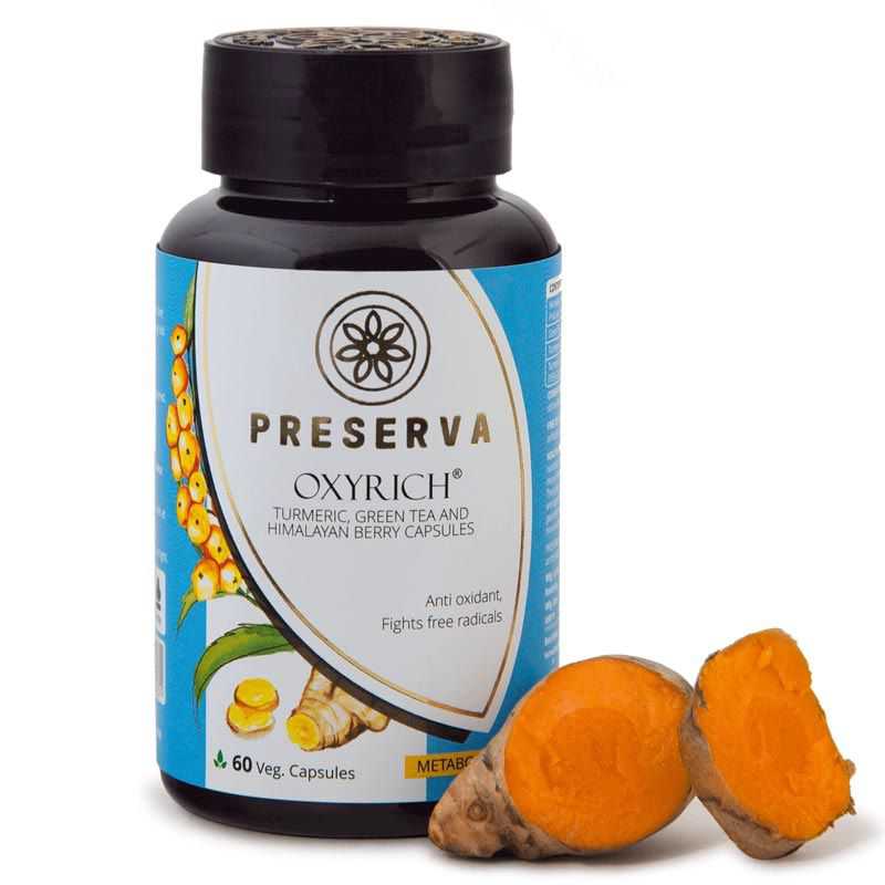 Preserva Wellness Oxyrich Capsules with sliced curcumin on a white background.
