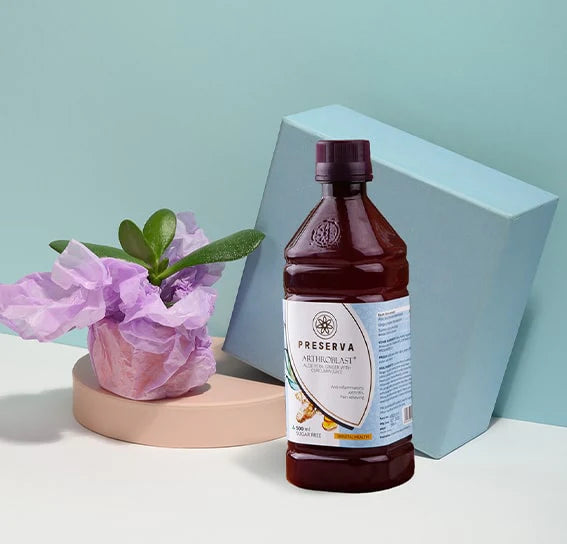 Arthroblast Juice in front of a blue box and circular cream-coloured stand. The stand has a flower pot on it.