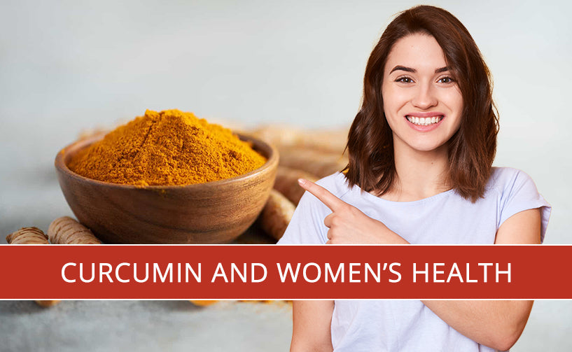 A woman smiling and pointing at the wooden bowl of pure organic curcumin powder