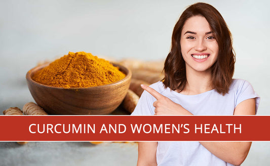 A woman smiling and pointing at the wooden bowl of pure organic curcumin powder