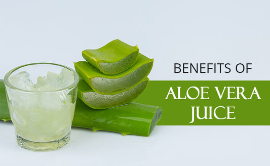 Sliced aloe vera next to its juice in a small glass