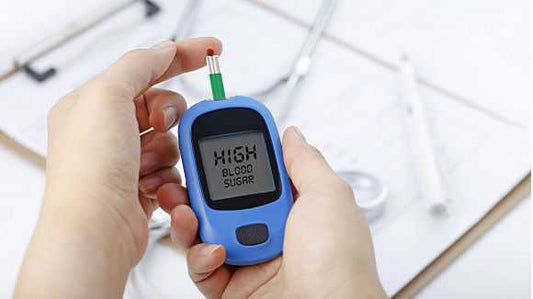 Person checking blood sugar level in a glucometer