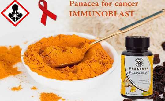 Immunoblast capsules with curcumin in a white bowl and golden spoon