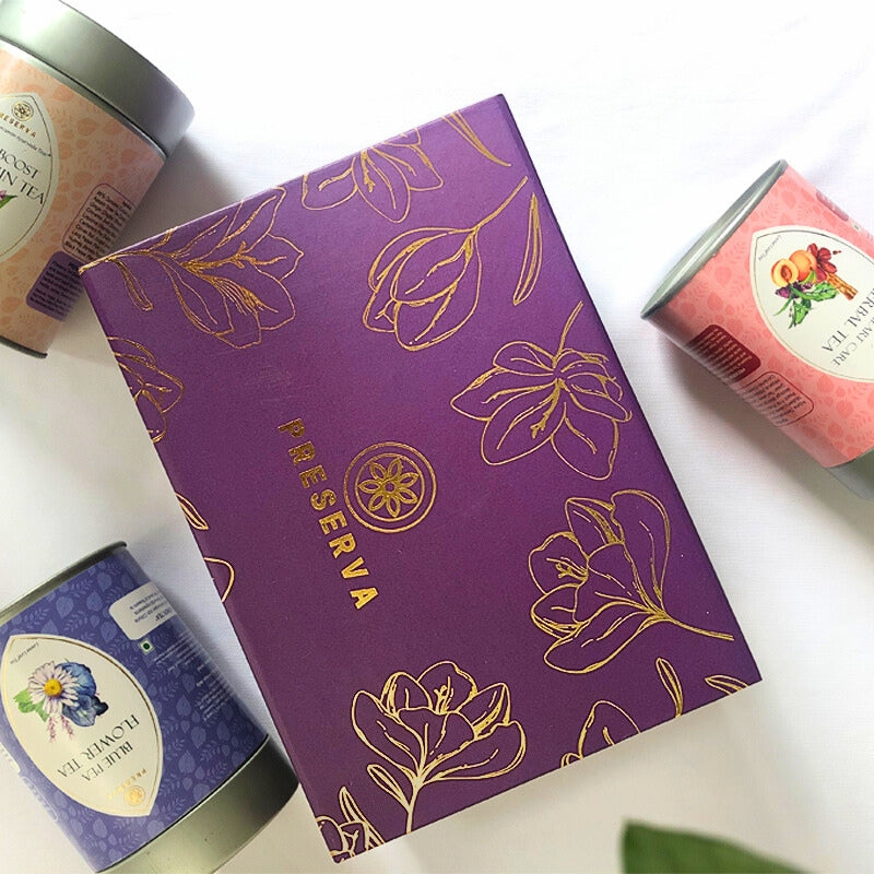 Preserva Wellness Tea gift box next to tea containers