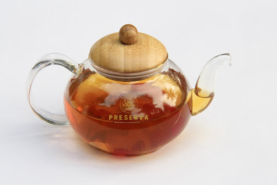 Tea glass pot with a wooden cover