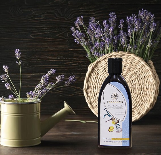Arthrogold Oil next to lavenders in a watering can and wooden basket.